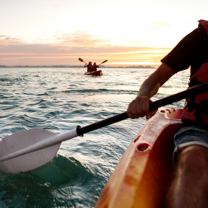 man kayaking in ocean
