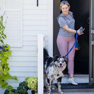 woman with dog at cottage